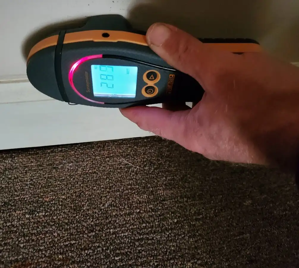 Moisture detection at baseboard during Storm Damage Restoration in Bridgeton